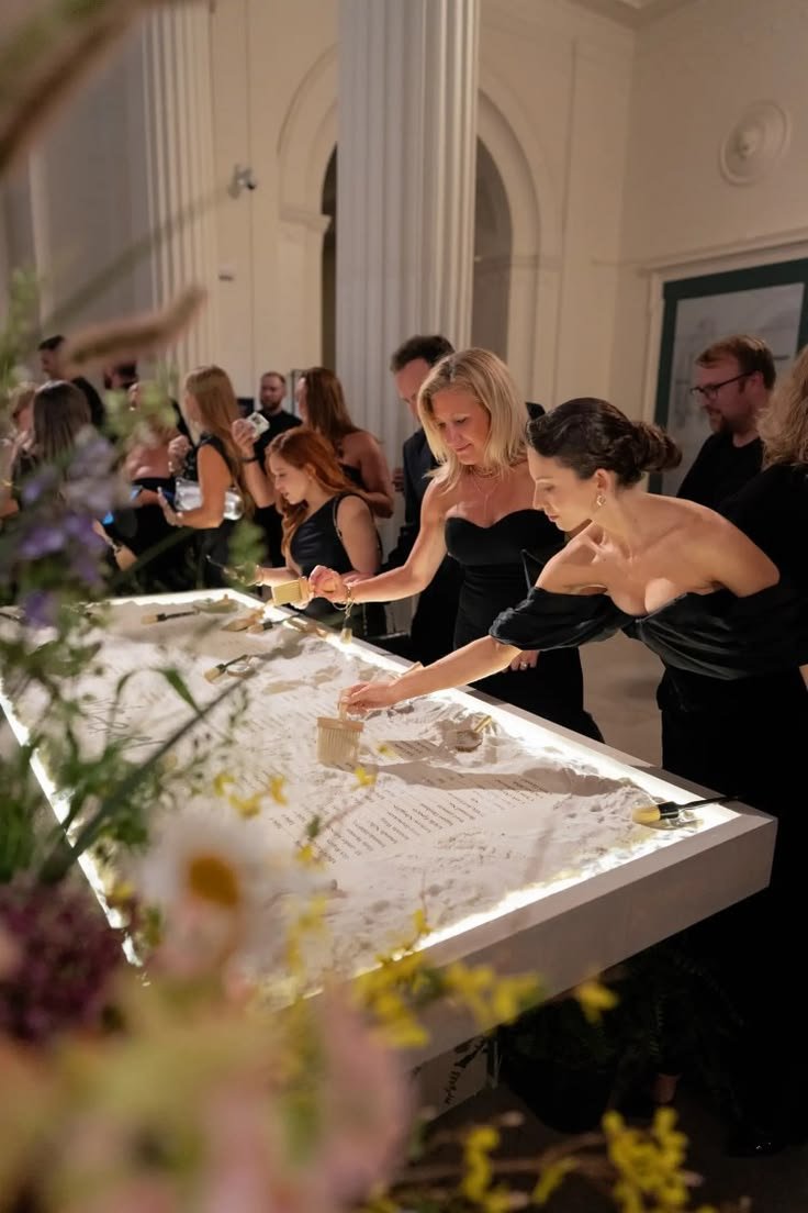 Guests engaging with an illuminated interactive event installation